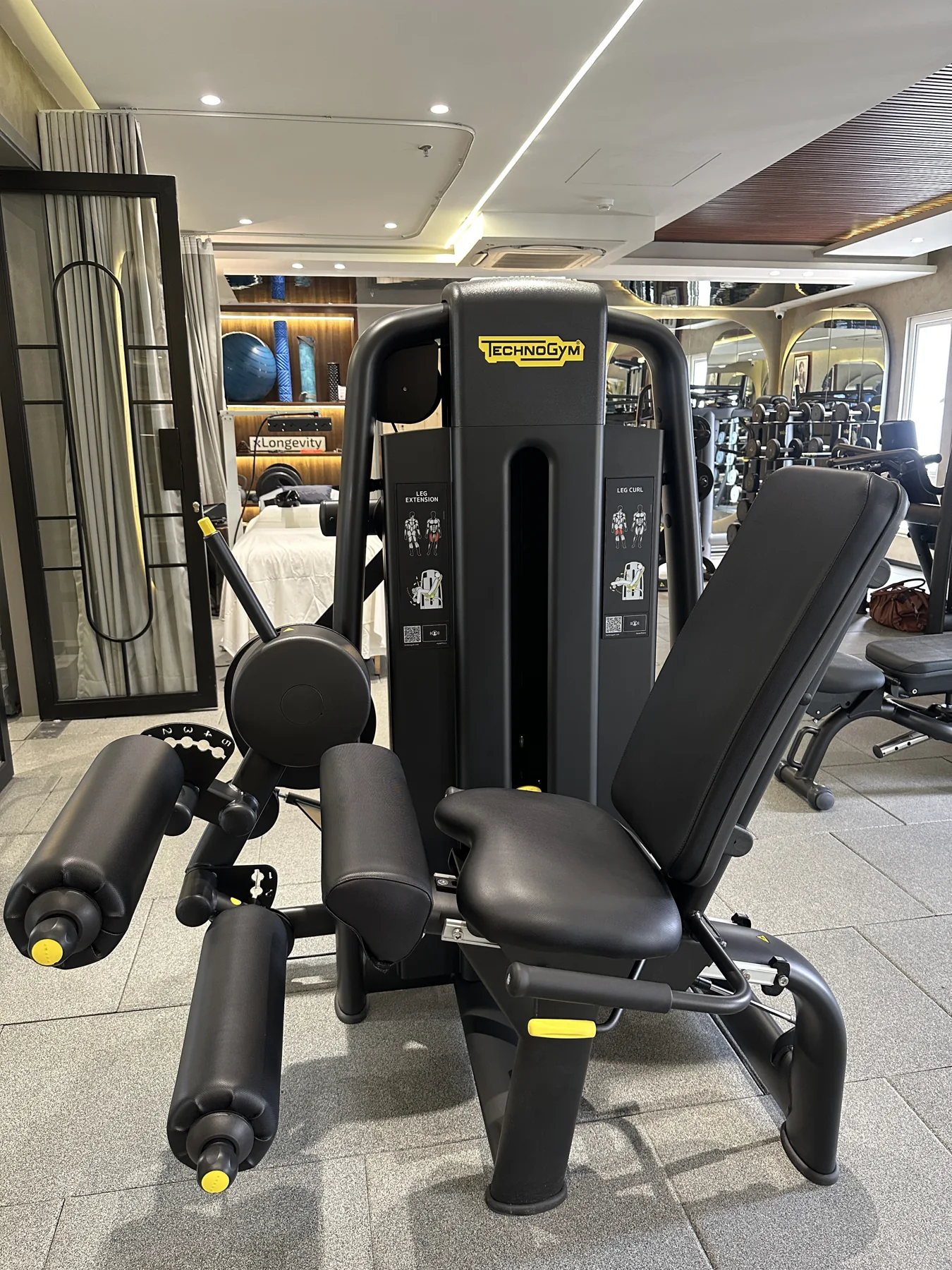 A seated leg machine on the training floor